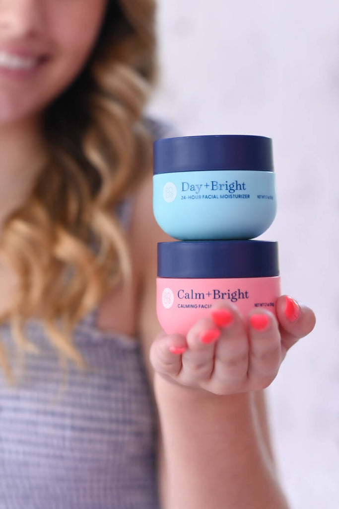 Young girl displaying Day+Bright 24-Hour Facial Moisturizer and other Bright Girl products